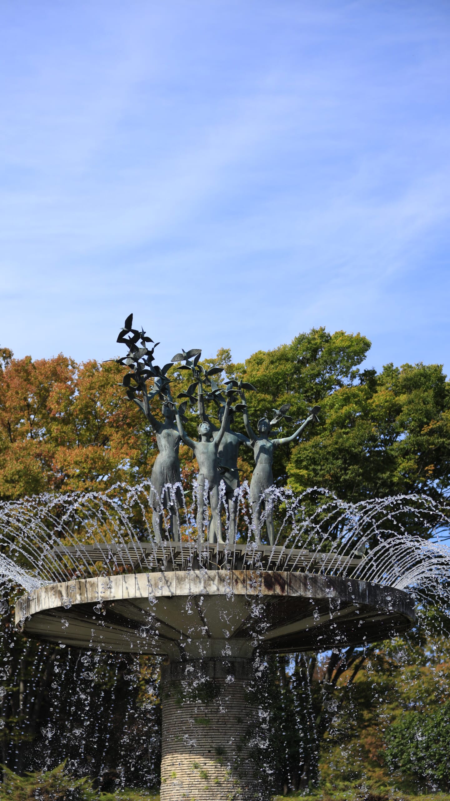 国営昭和記念公園の立川口から続くカナールで、噴水の水が空へ高く広がる様子を低い位置から見上げた写真