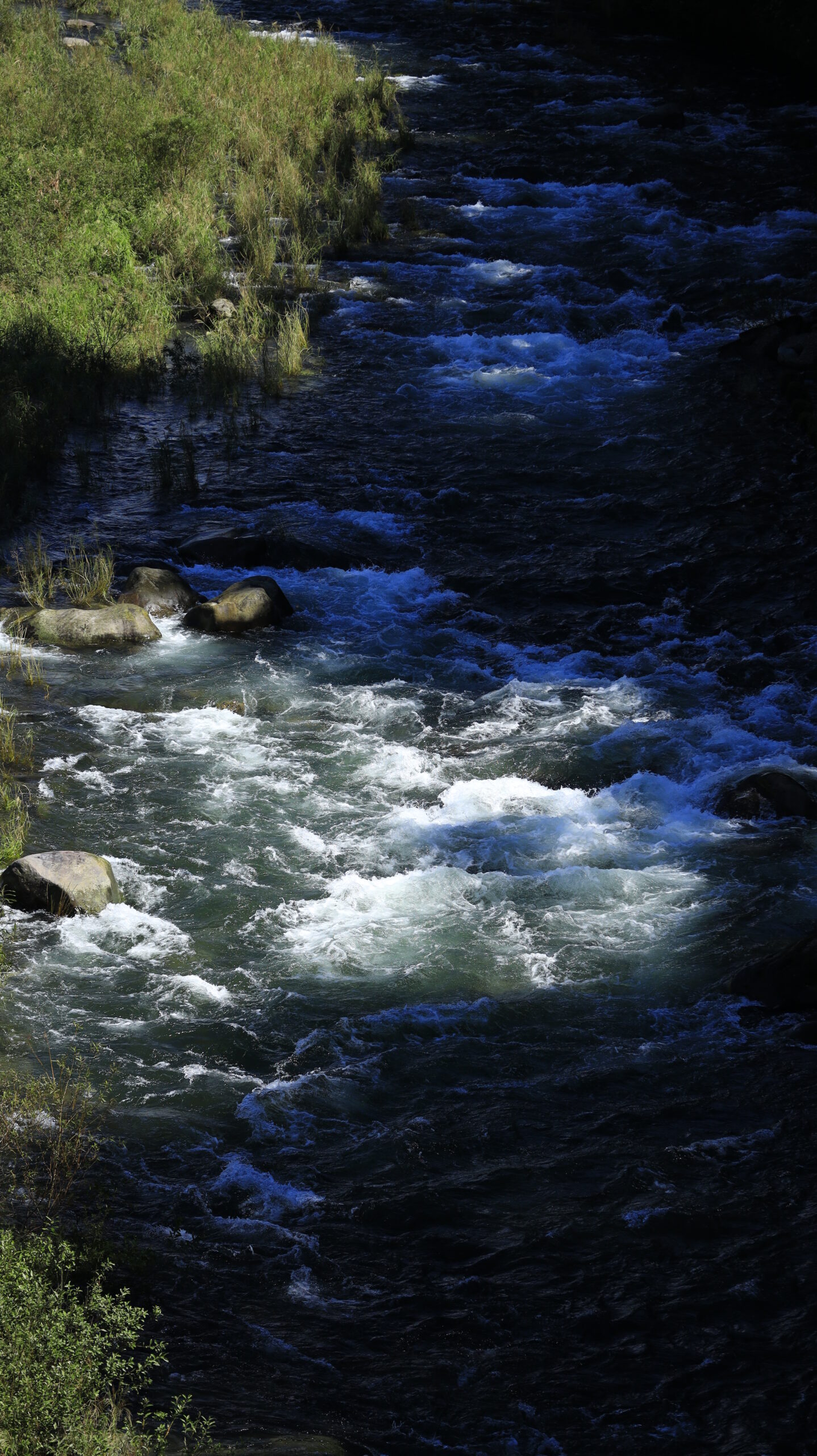 The water's surface glistening in the sunlight on a river near Yagihara's Red Spider Lily Village